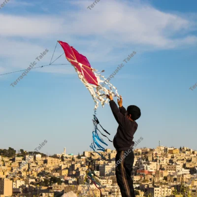 boy-kite-amman-cityscape